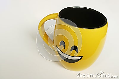 Mug on white background with smiley face and yellow color Stock Photo